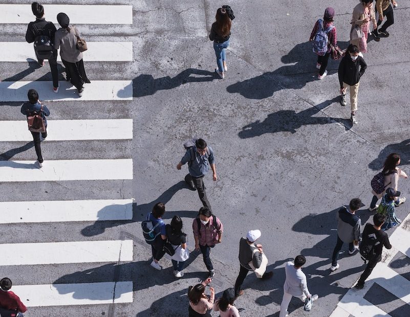 aerial photography of people crossing pedestrian lane